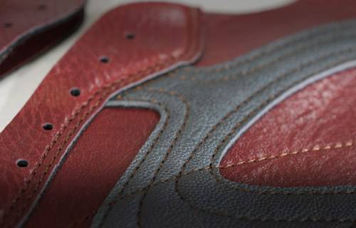 Close-up of a red and gray sneaker's textured surface.