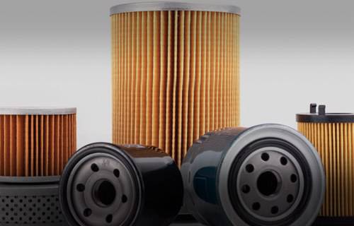 Various types of oil filters arranged side by side.